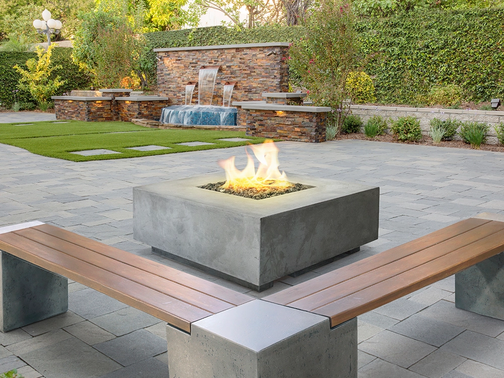 Backyard design with paving stone patio, stone fire pit, and stone water feature. Diamond Bar, Los Angeles County. 