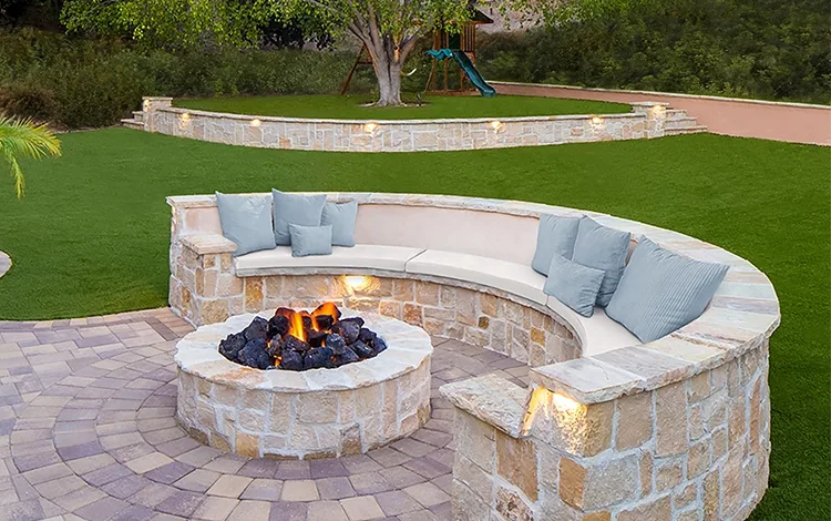 Stone fire pit on a turf lawn. 