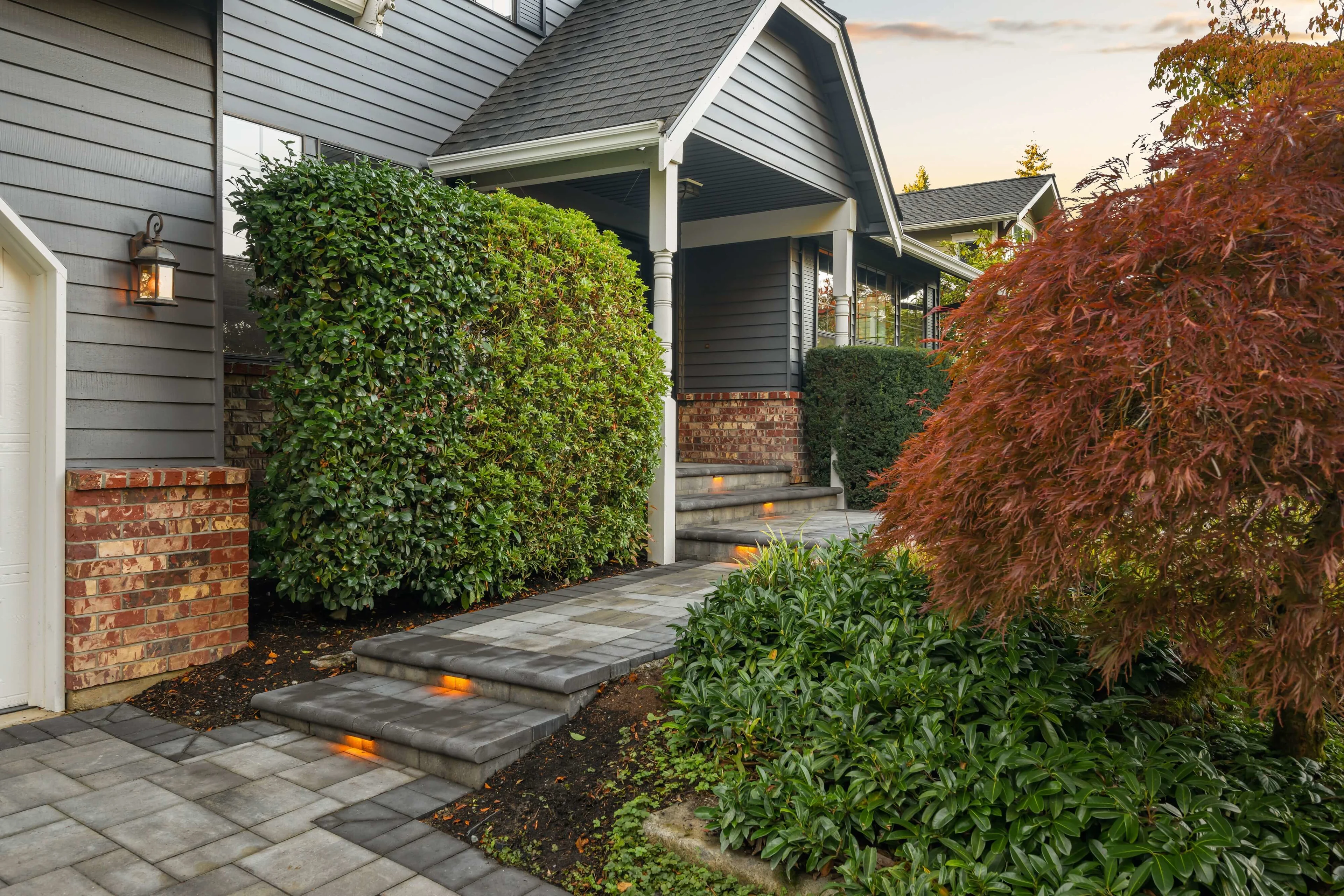 Built-in lighting on gray paver walkway and front entry