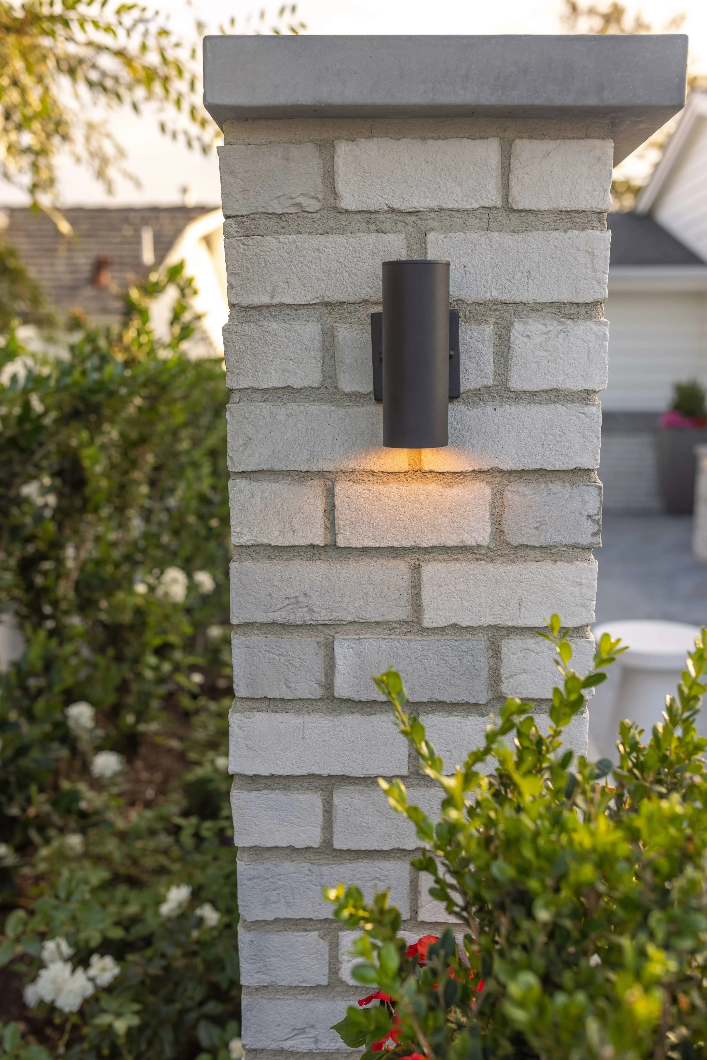 Built in landscape lighting on stone pillar