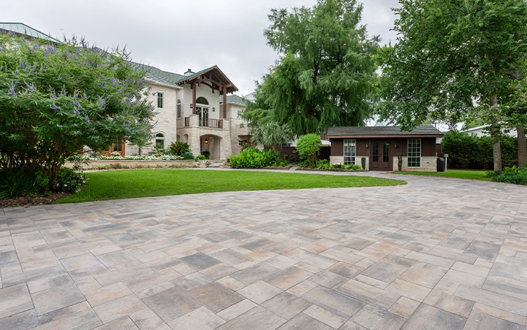 Large driveway in front of a Houston home made of paving stones