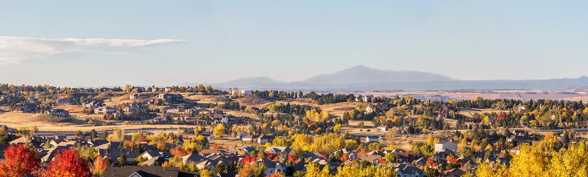 Colorado Living. Centennial, Colorado - Denver Metro Area Residential Autumn Panorama with the view of a Front Range mountains in the distance