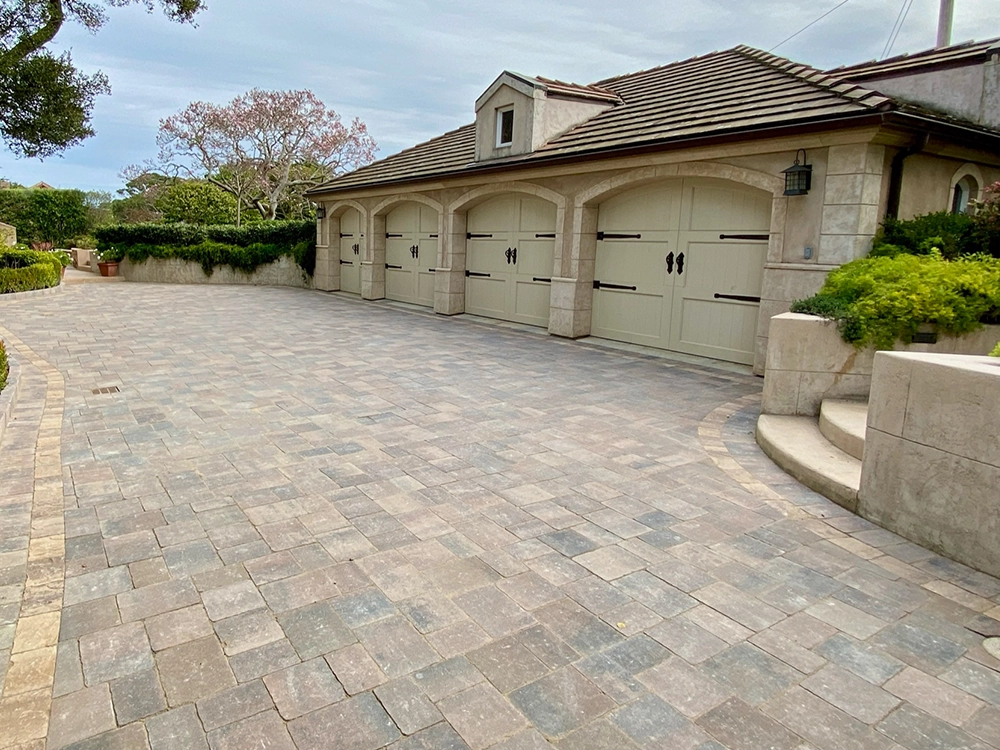 Large paving stone driveway in Sandy Springs with three car garage. 