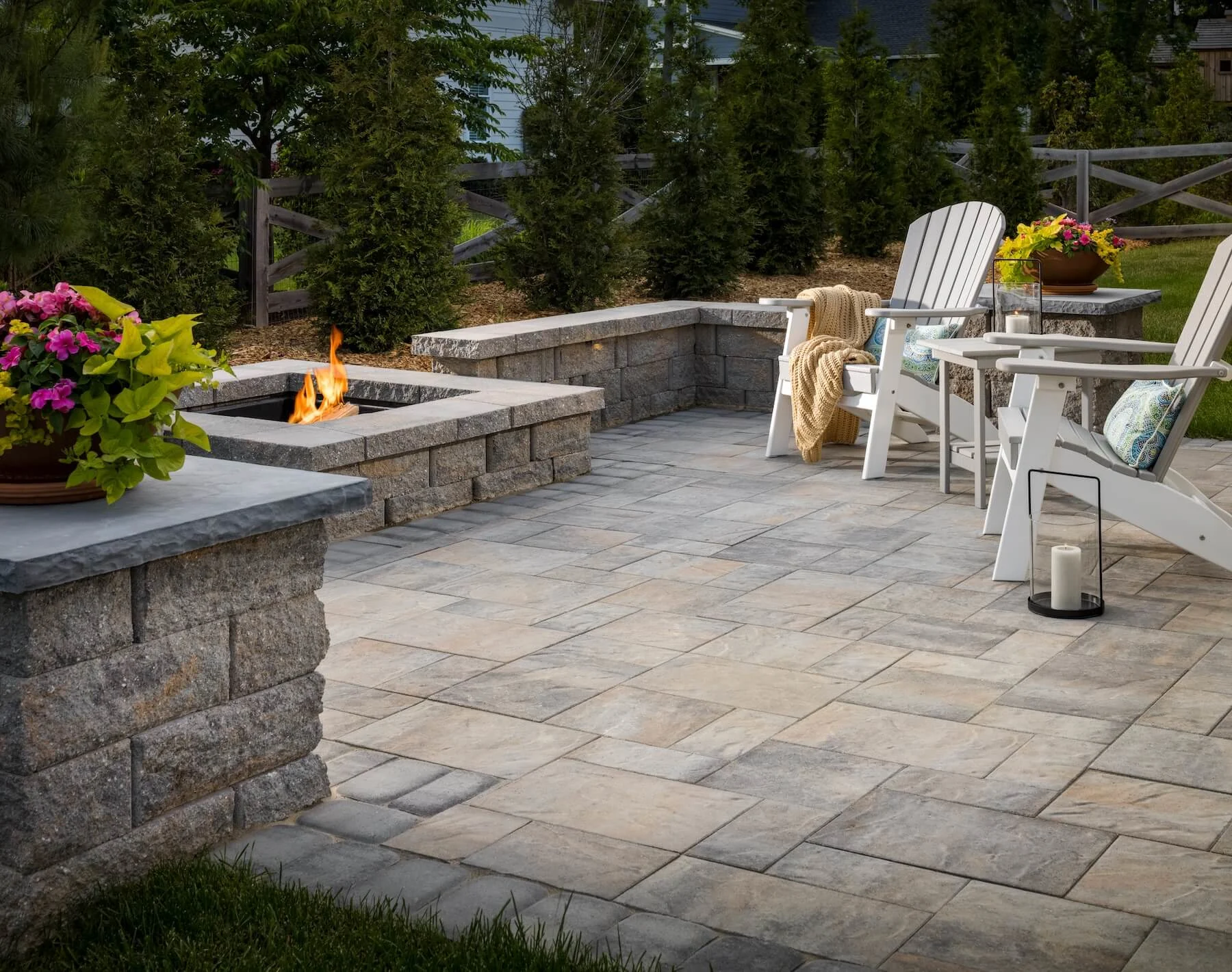 Multi toned blend paver patio with fire pit and sitting walls in backyard