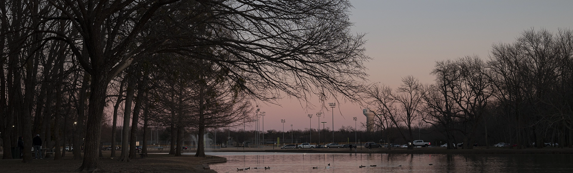 Scenic Towne Lake Park lined with bare trees during sunset at McKinney, Texas