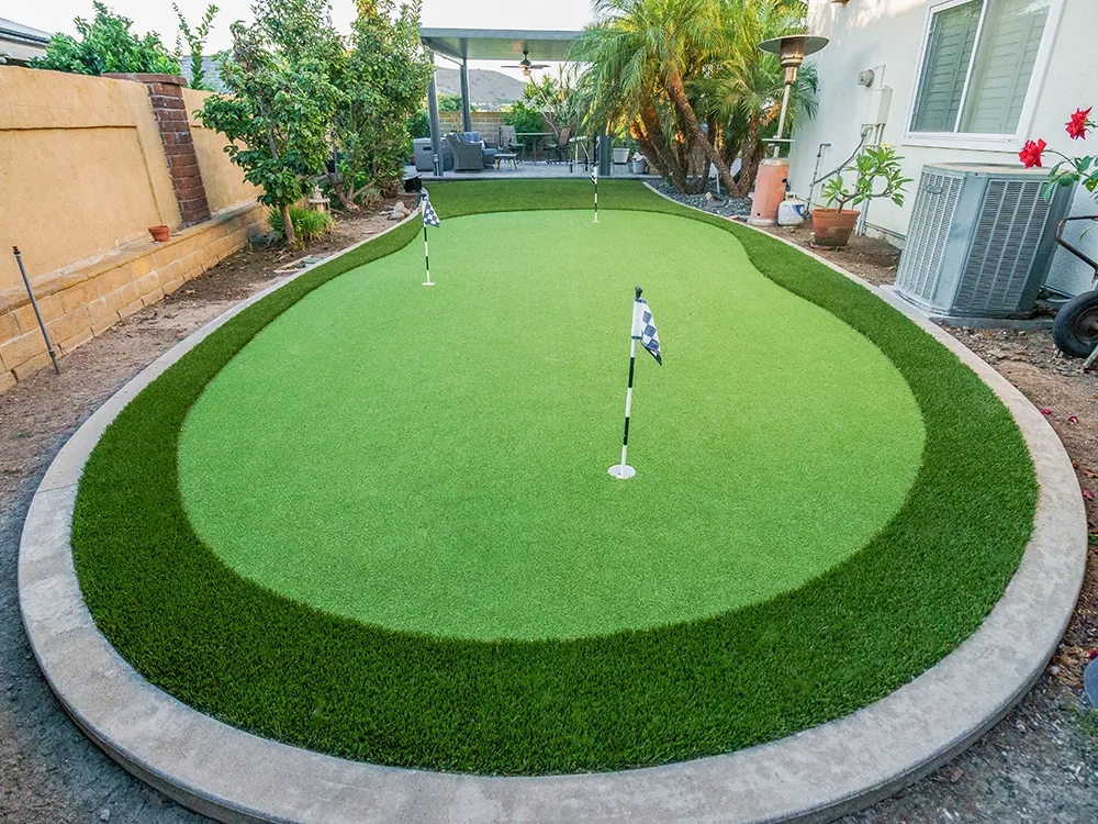 Small putting green installed in a backyard.