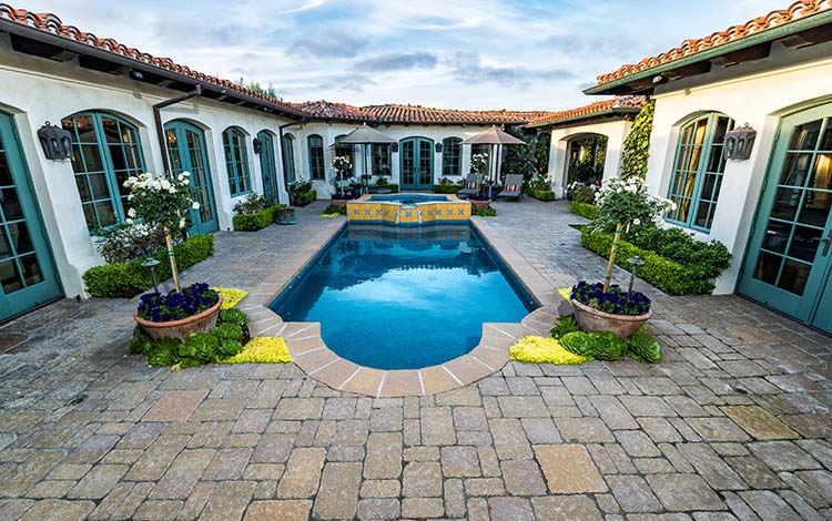 Paver pool deck, pool, water, courtyard pool, water fall, patio furniture, backyard, paving stones, California, daytime