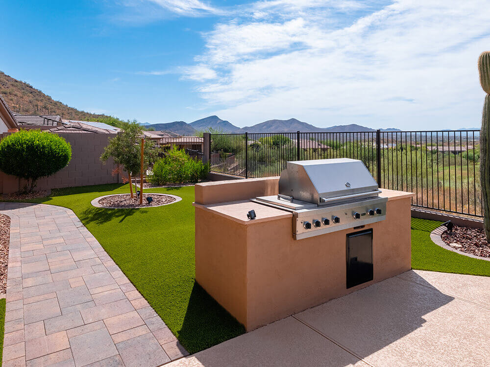 Outdoor kitchen with paving stone walkway installed by System Pavers in Arizona