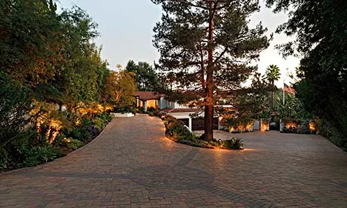 Outdoor lighting, paver driveway, split driveway, driveway design, curb appeal, pavers, California, evening
