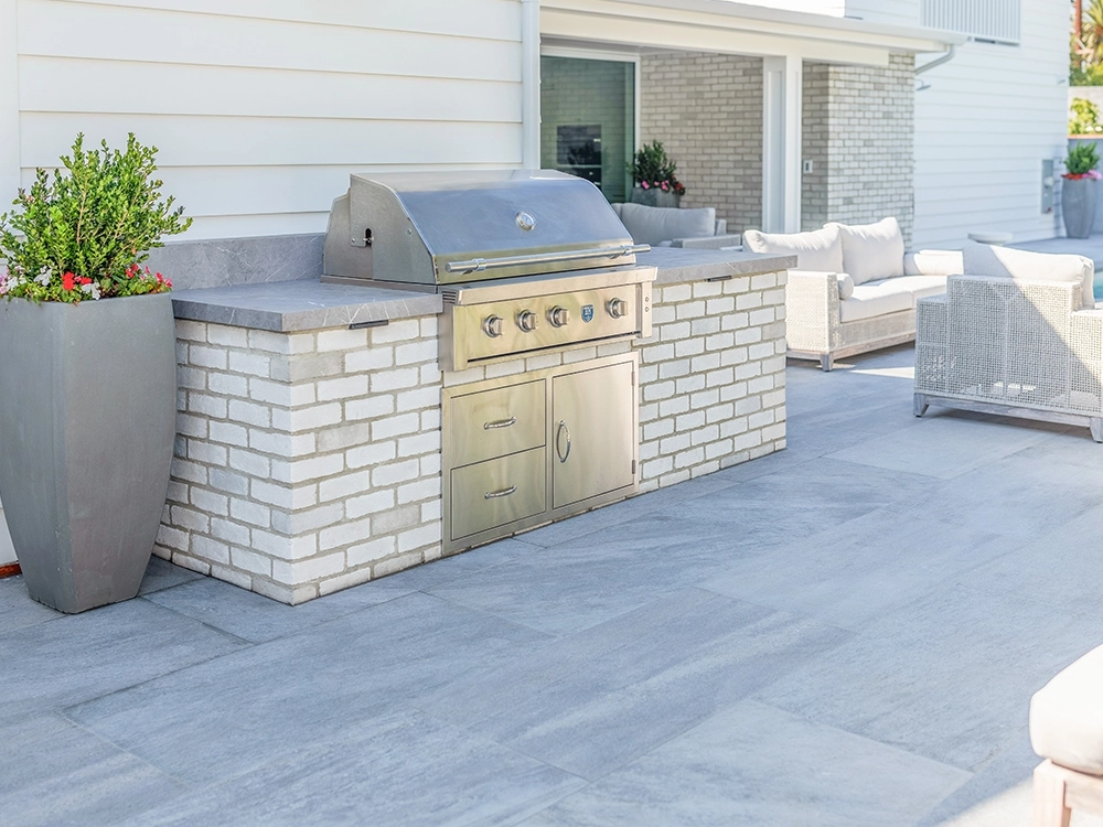 Light paver outdoor BBQ on large paver patio
