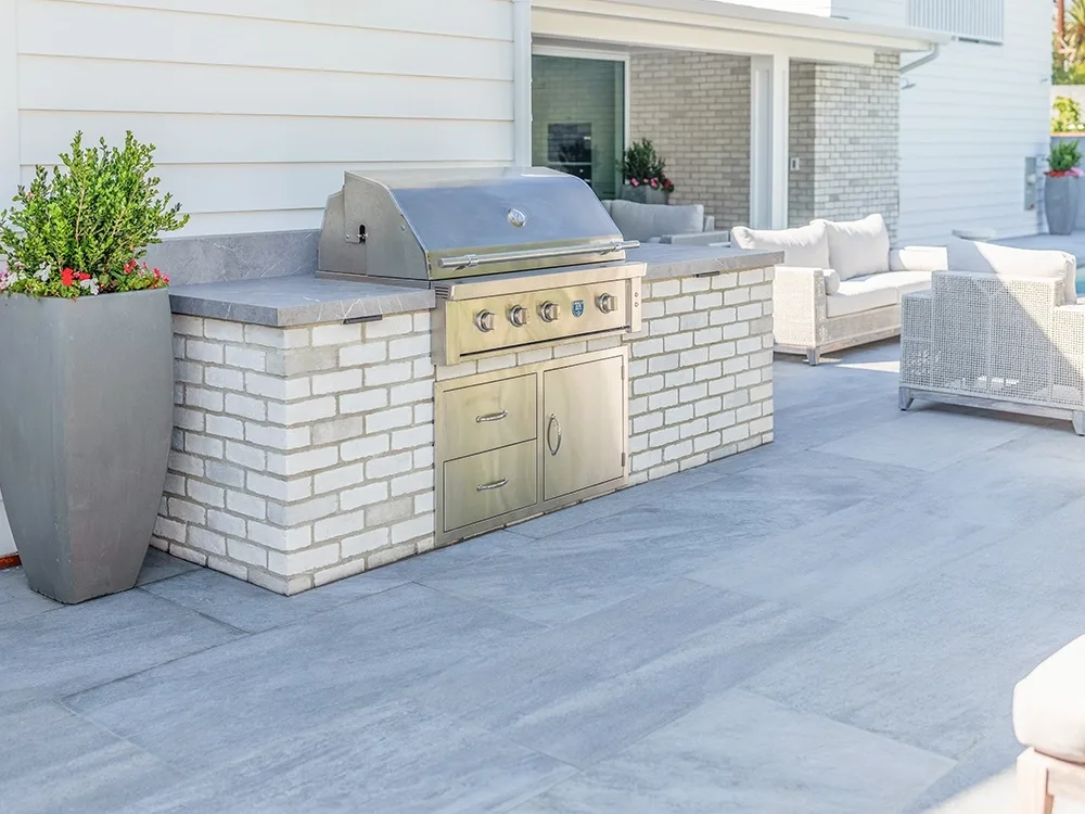 Light paver outdoor BBQ on large paver patio