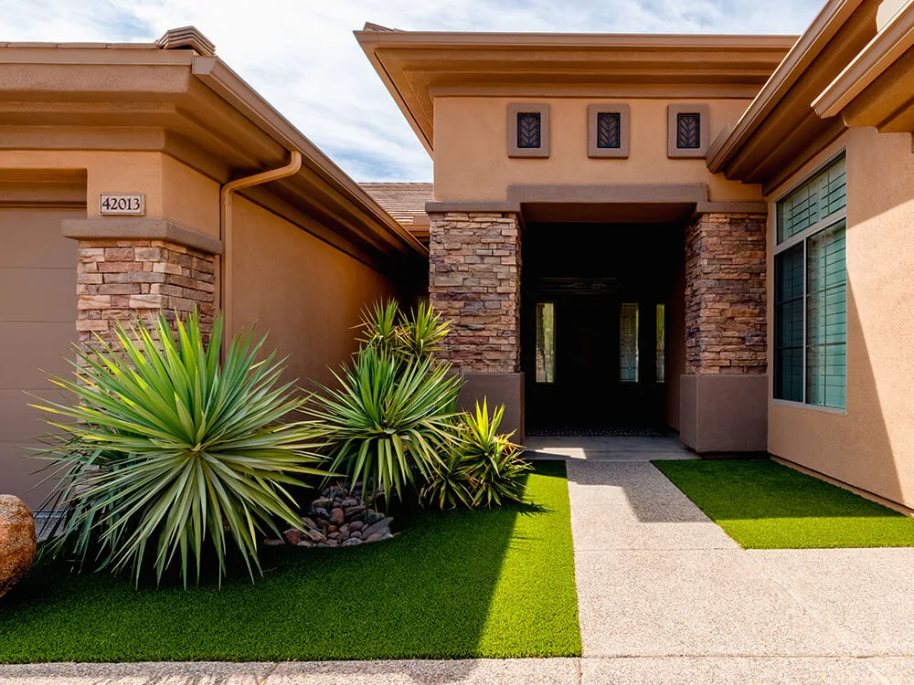 Front paving stone walkway and turf lawn installed by System Pavers