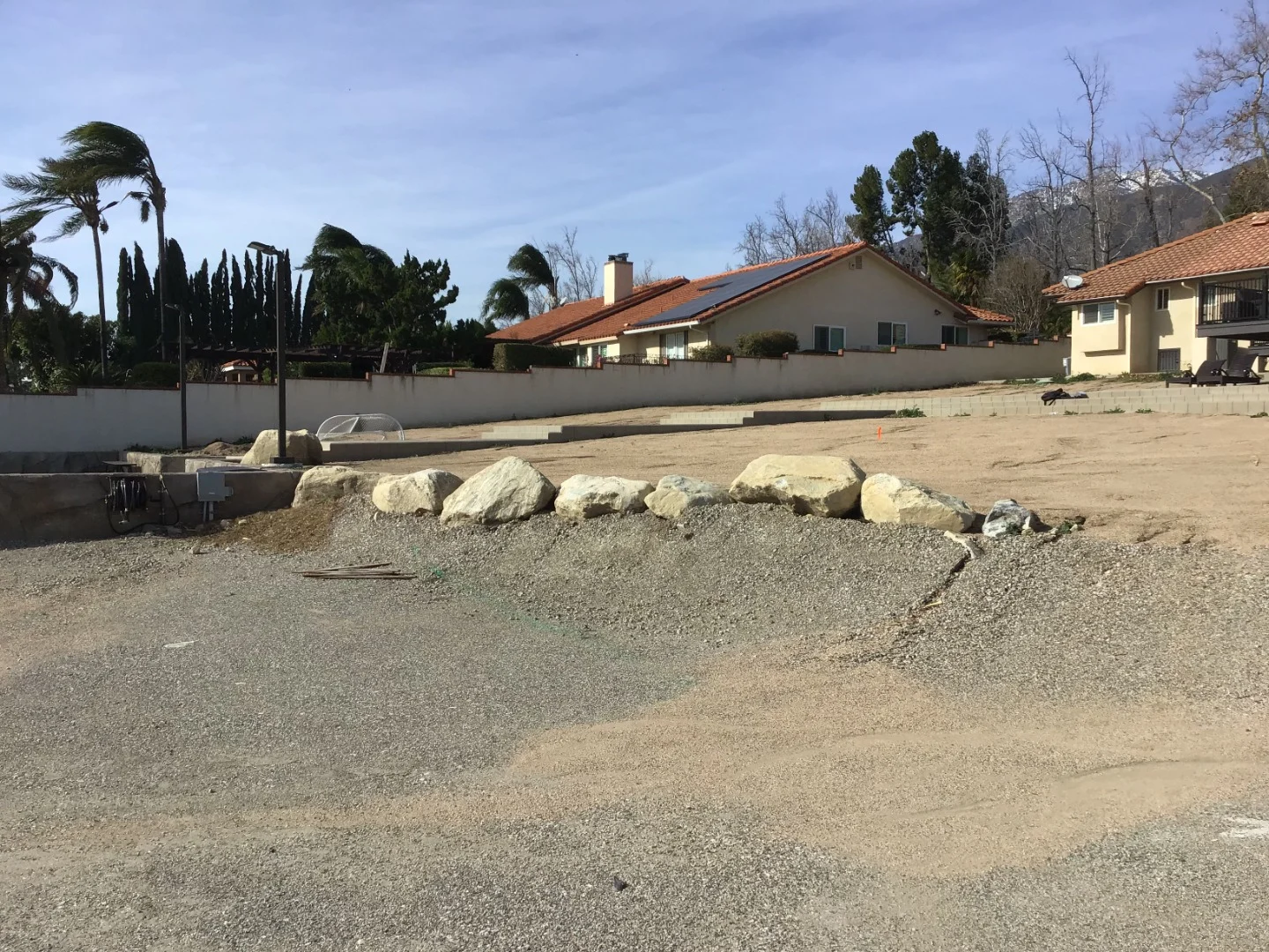 Dirt backyard before System Pavers transformation side angle