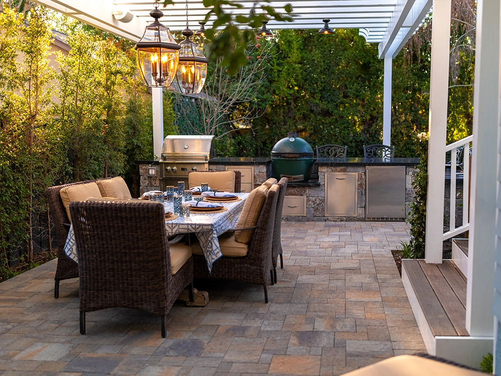 Backyard paver patio with built-in kitchen and pergola. 