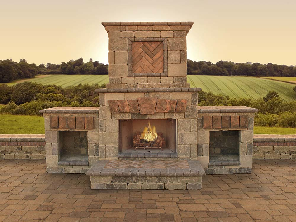 Outdoor fireplace, fire, lit, paver patio, outdoor living, rolling hills, view, retaining wall, backyard, paving stones, universal region, daytime, evening