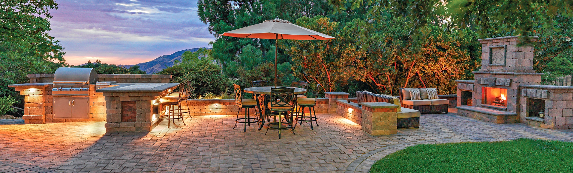 Incredible paver patio with built-in stone outdoor kitchen with grill and built-in outdoor fire place. 