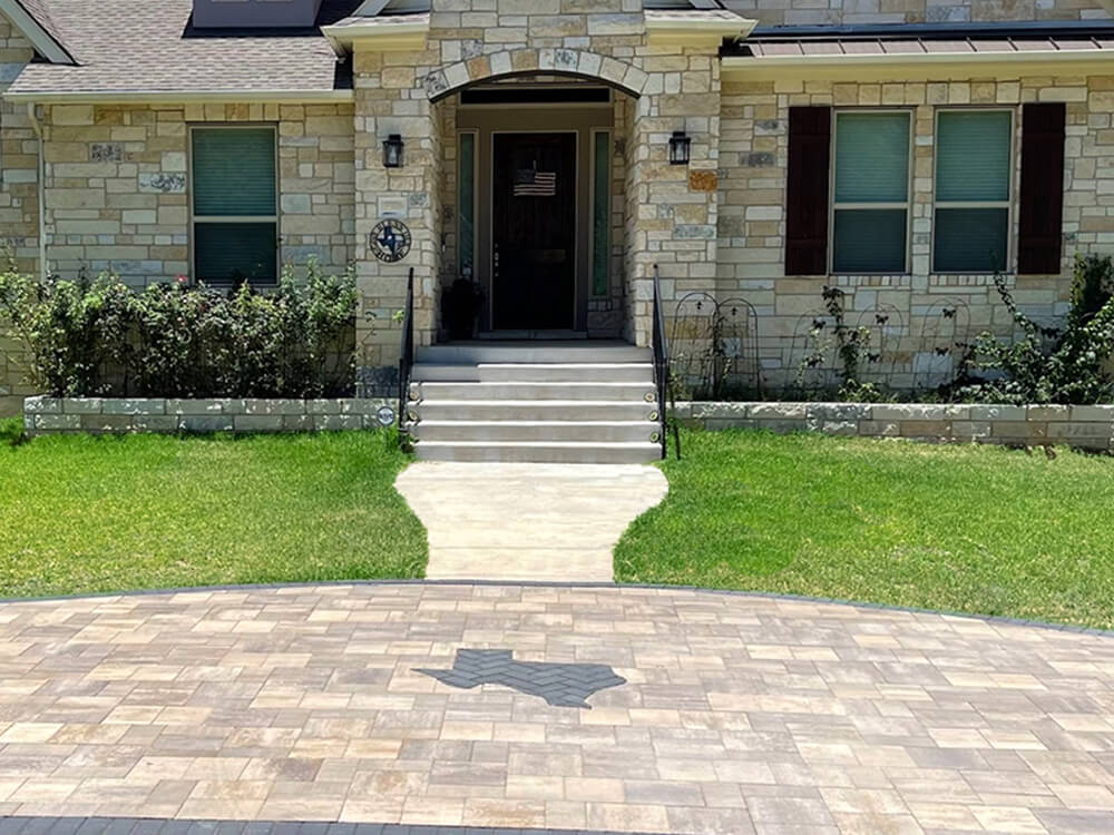 Front paver driveway with the state of Texas design. 