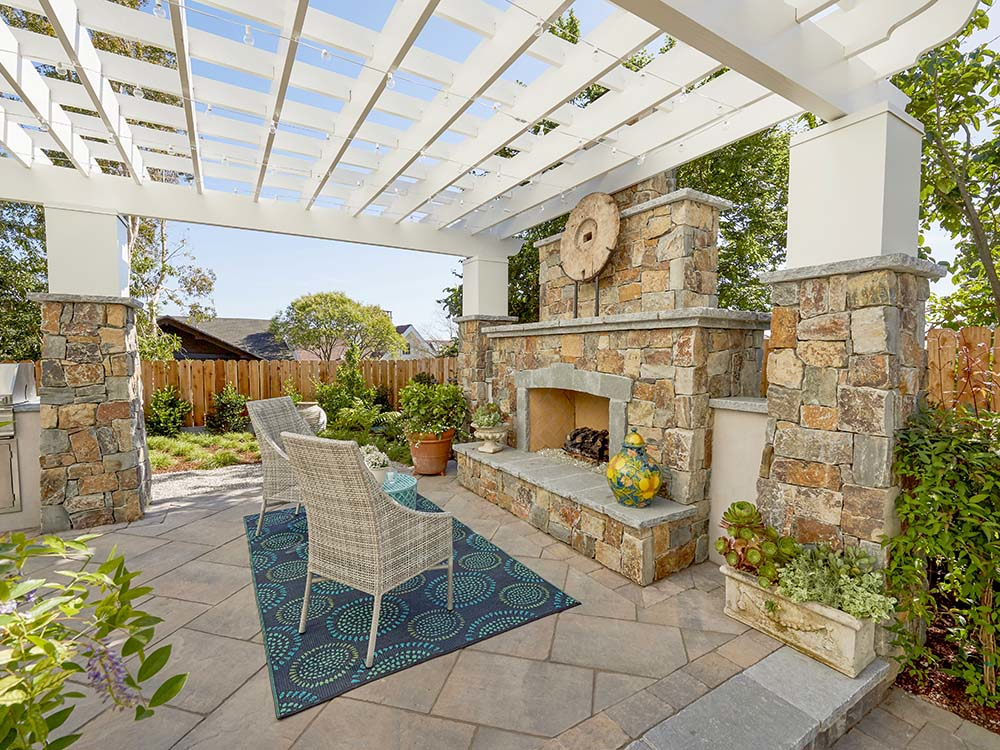 Light and bright patio with pergola and built-in fire place