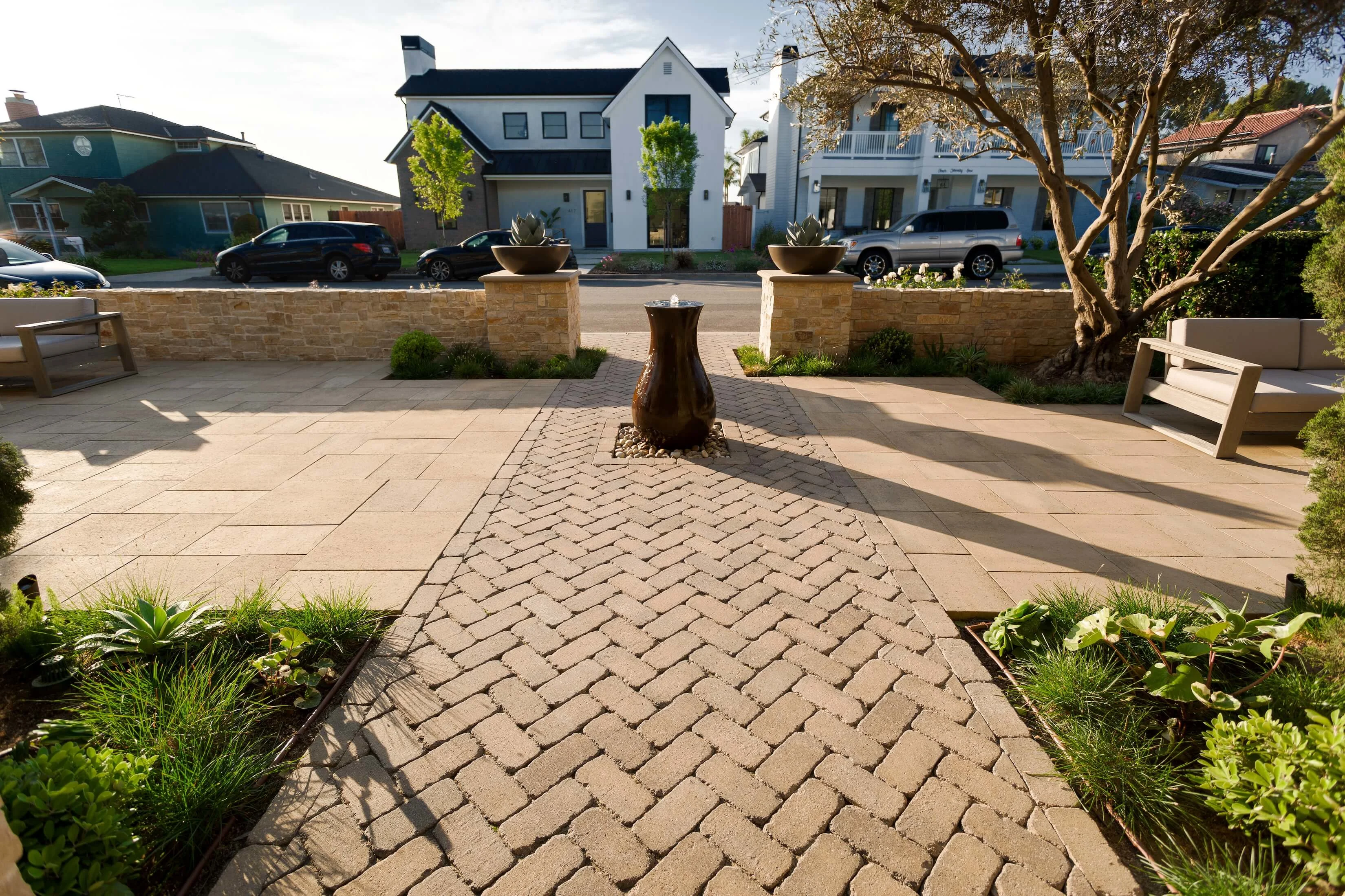 Water feature at front yard entrance with paver courtyard