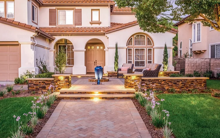 Front of a lovely home in Diamond Bar, LA. Paving stone walkway, front stone patio with stone walls and lighting installed by System Pavers. 