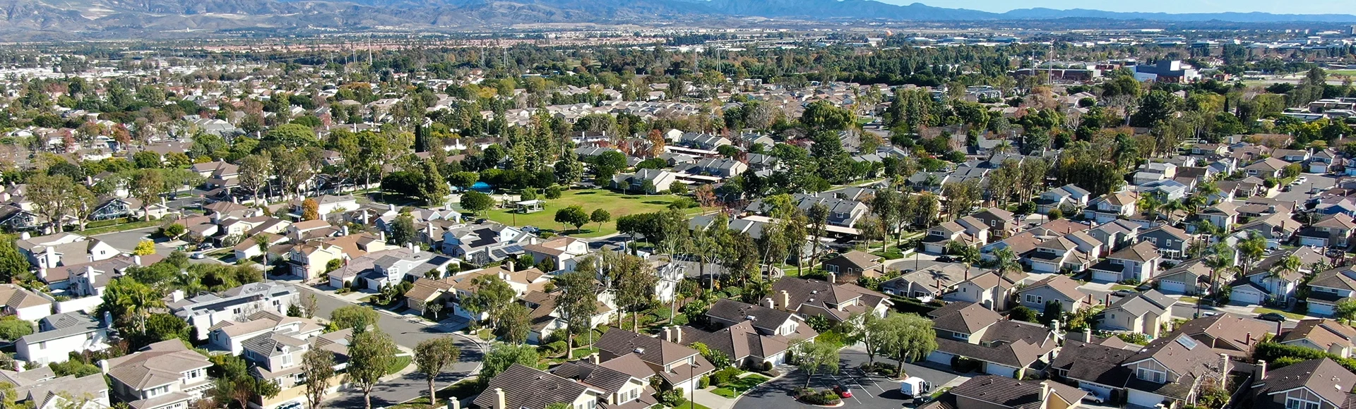 Aerial view of residential suburban packed homes neighborhood during blue sky day in Orange County, USA