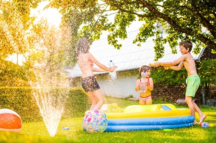 kids playing in sprinkler