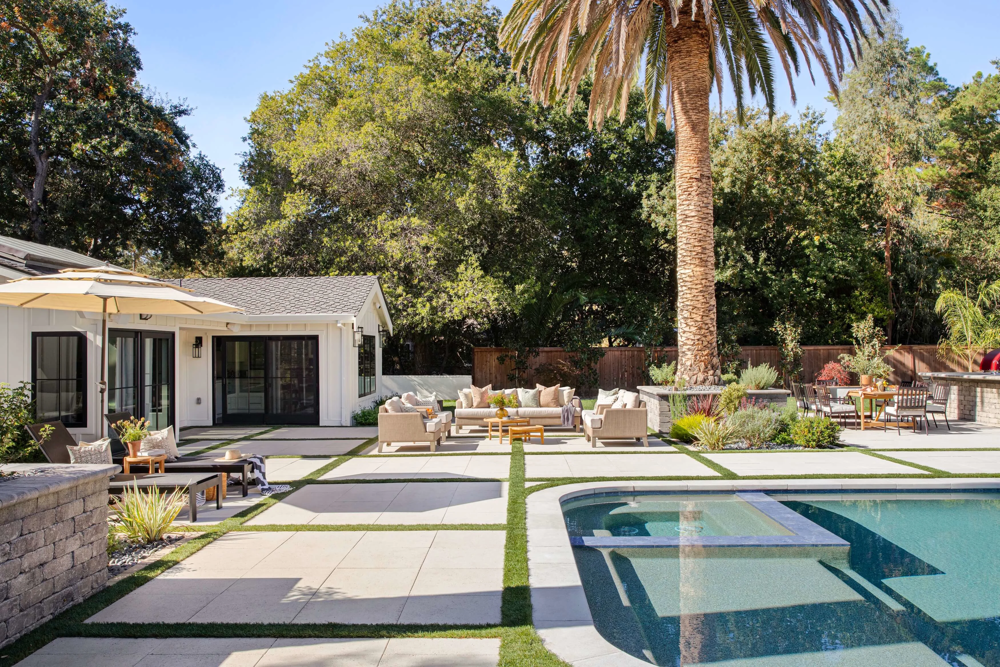 Paver pool deck and patio lounging with retaining walls and backyard entertainment areas