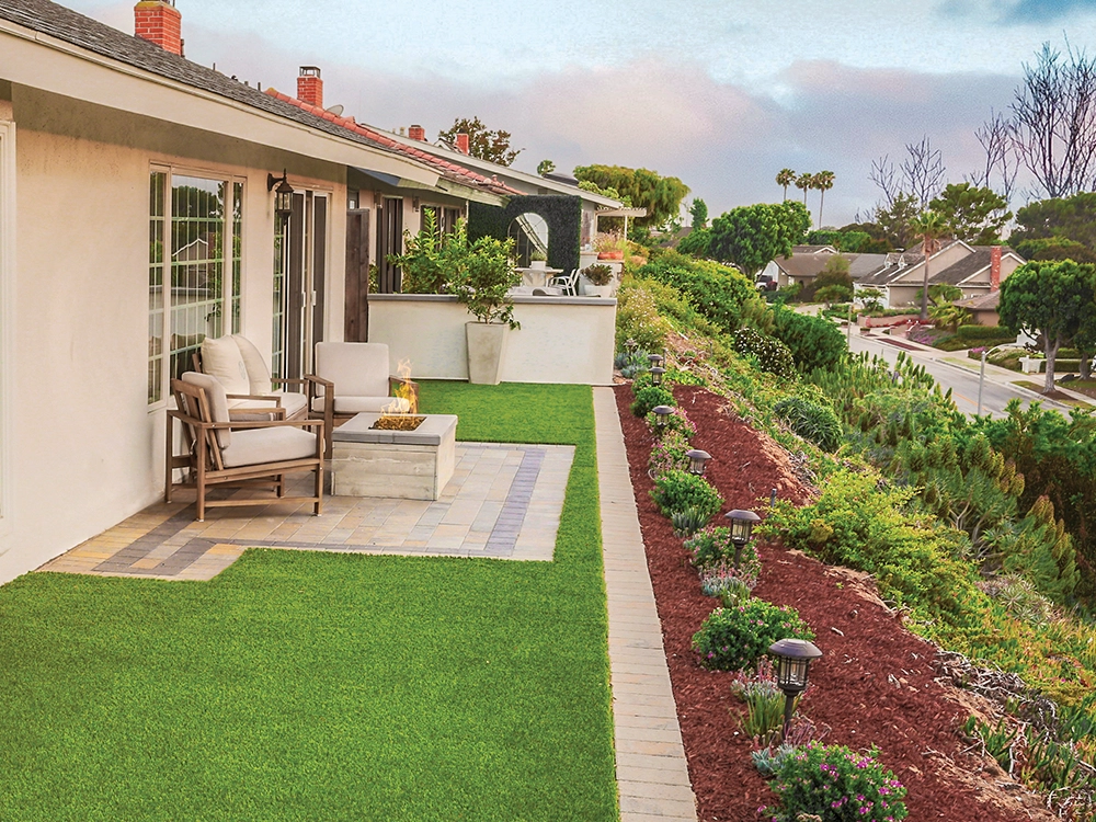 Small back paver patio and artificial turf insert on a small California home. 