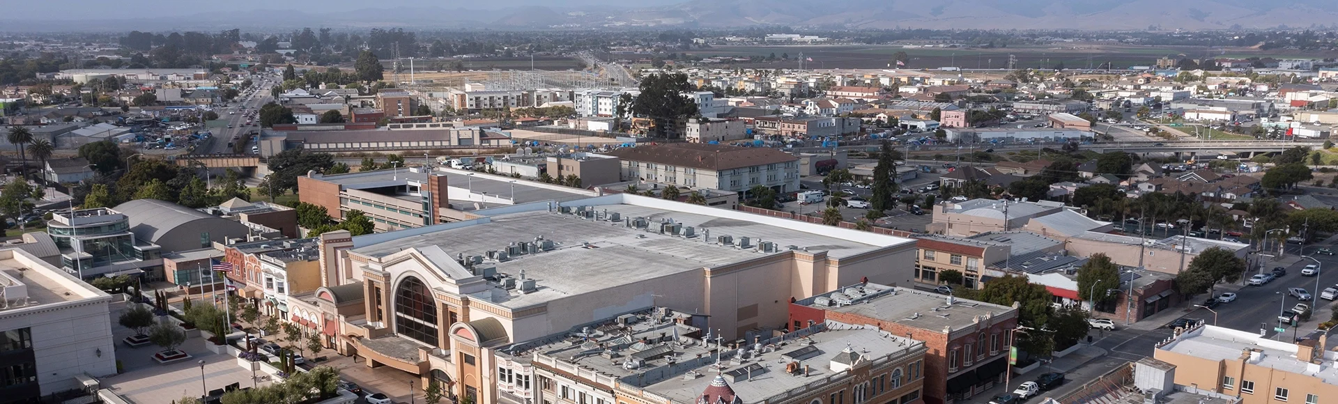During a break in the fog, afternoon sunlight shines on the historic city center of downtown Salinas, California, USA.