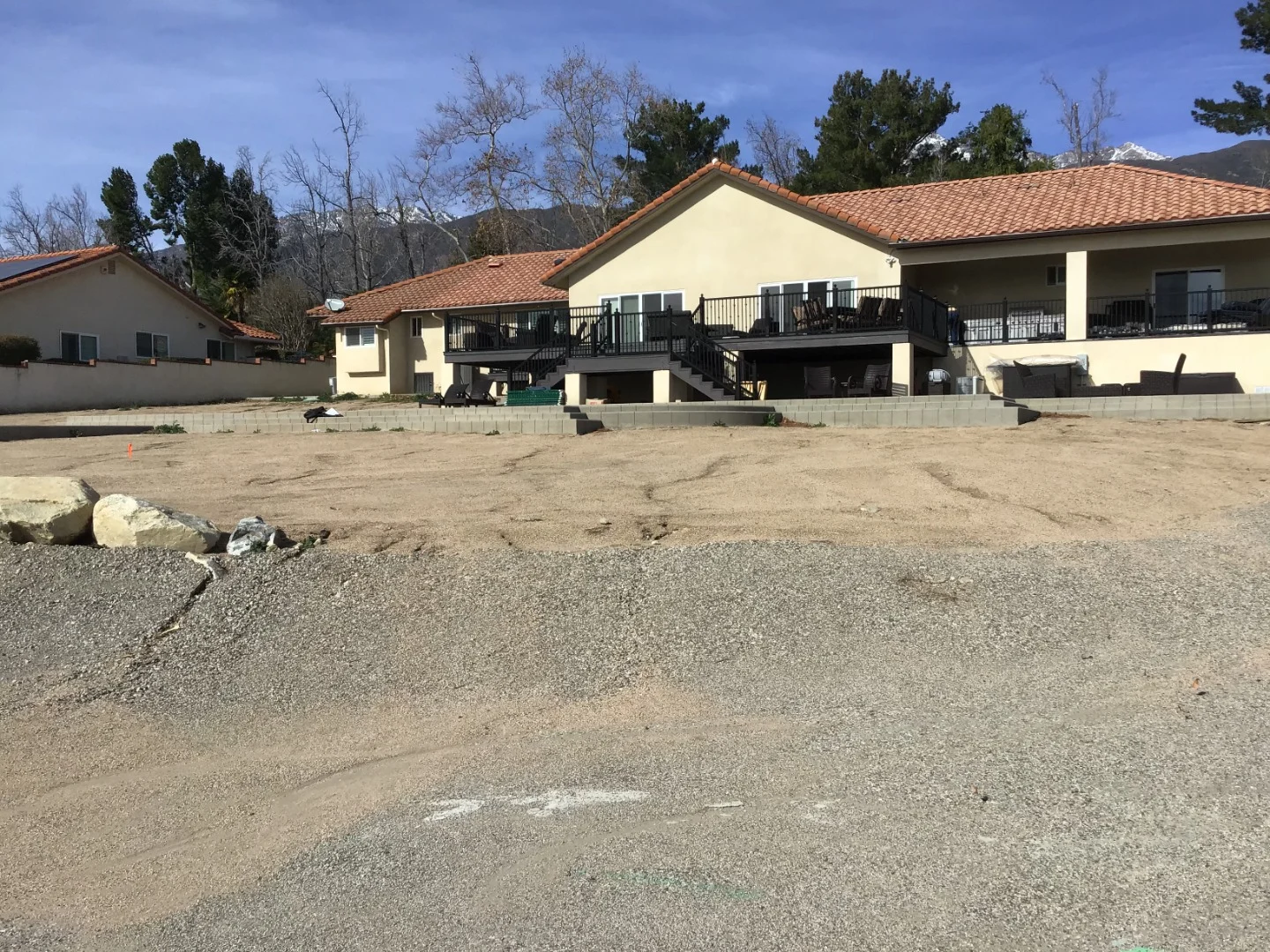 Dirt backyard before System Pavers transformation house pic