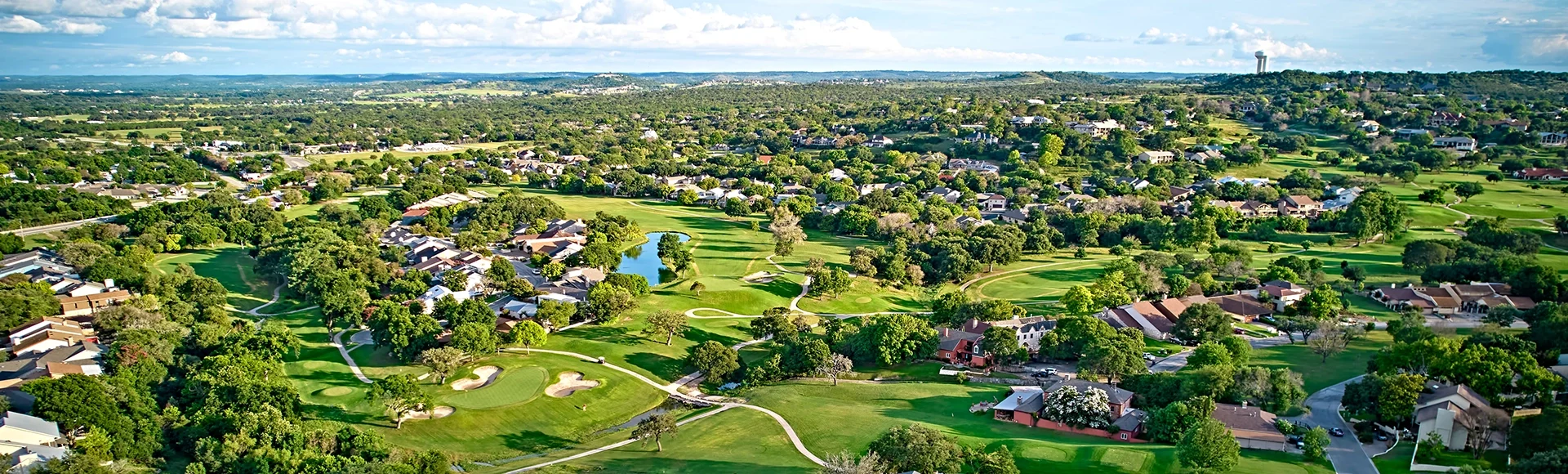 A bird's-eye view of the surroundings of residential buildings and beautiful green fields. Houston, Texas, USA. Development of suburban housing construction. general plan