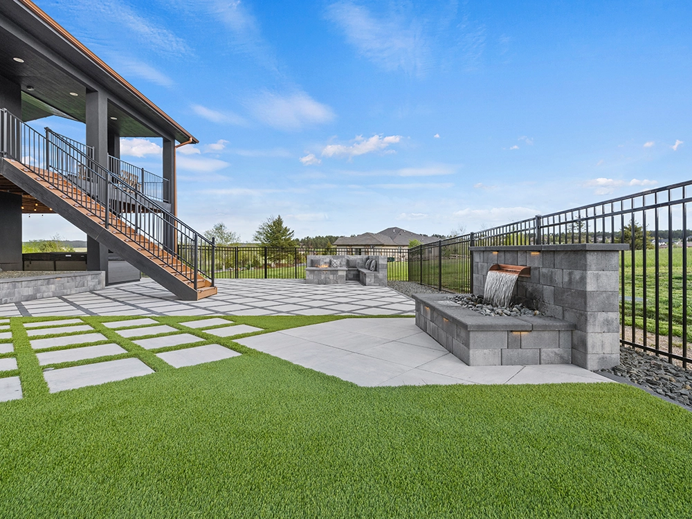 Large backyard transformation in Denver, Colorado. Features artificial turf, paving stones, fire pit and sitting area. 