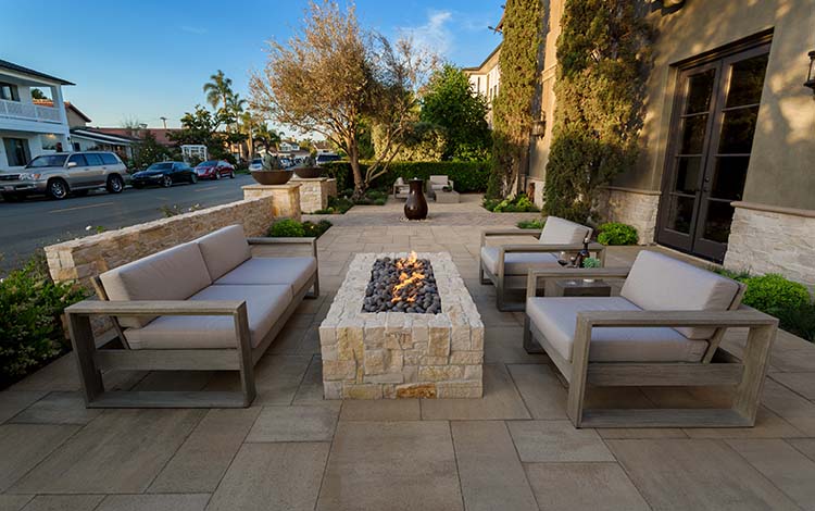 Fire pit, gas fire pit, lit, rectangular fire pit, pavers, patio furniture, side yard, paving stones, steps, California, daytime