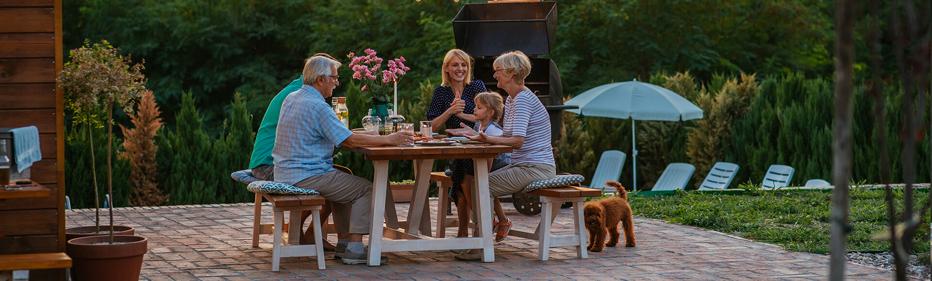 Family enjoying a pool with paving stone features and patio