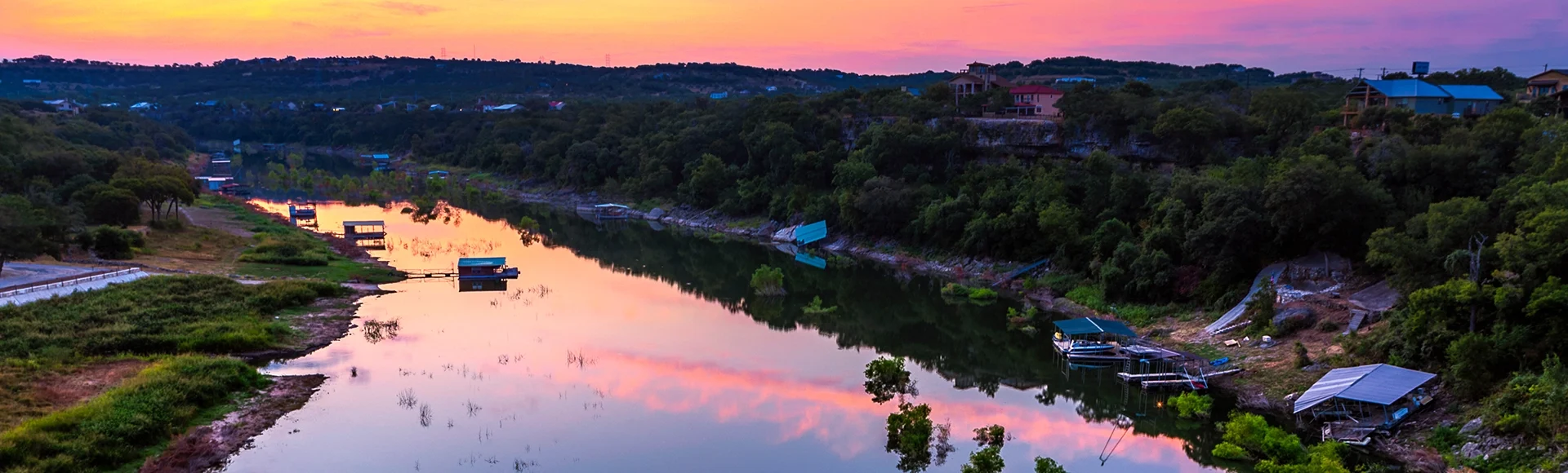The sun rises behind the Pedernales River in the Texas hill country