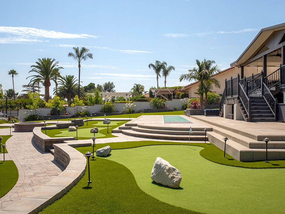 Back yard putting green with paver inserts and patio in a beatiful California backyard. 