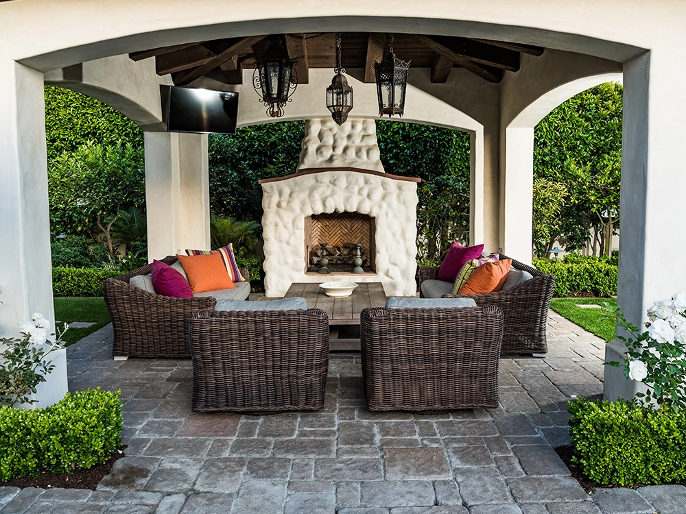 Lovely paving stone patio with covered patio and built-in stone fire place. 