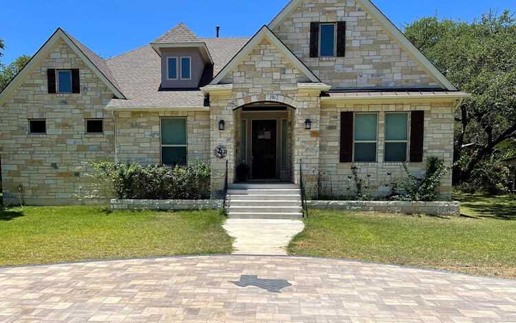 Texas home with paving stone front drive with the state of Texas designed in the stone