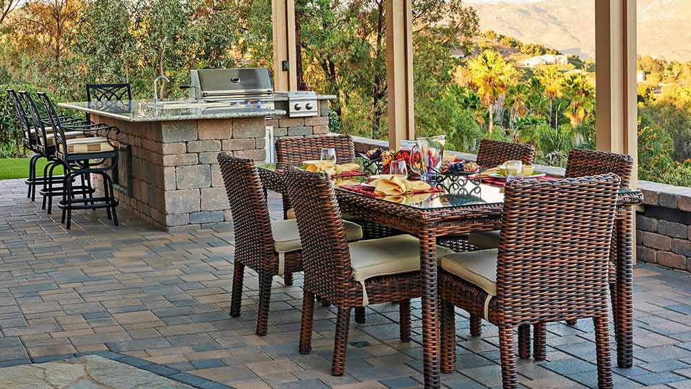 table on a paver patio with bbq island