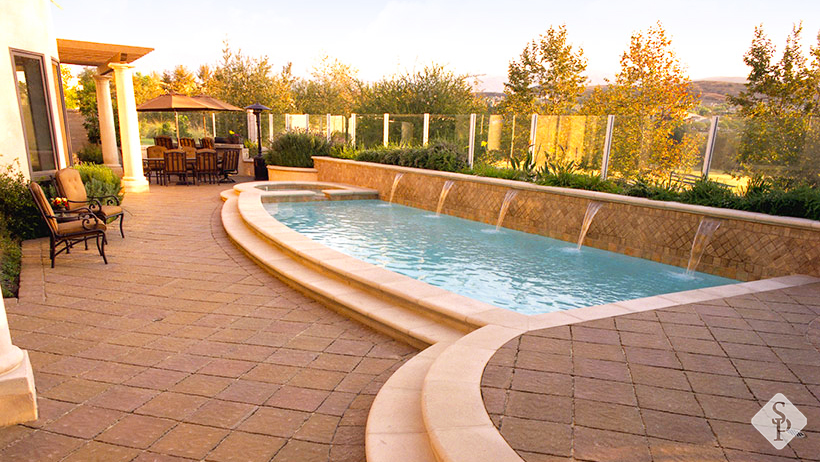 pool with waterfalls, pool deck pavers