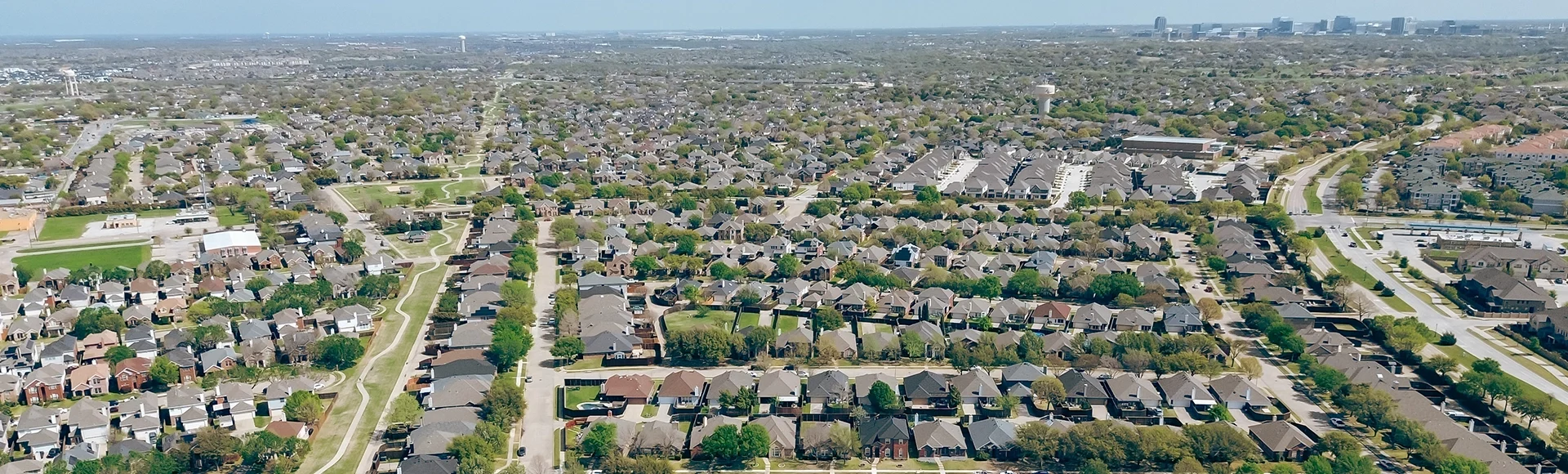 North Texas fast growing area with downtown Plano skyline in background, vacant land to grow near Worley and Memorial Drive in suburban residential neighborhood, The Colony, Denton County, aerial