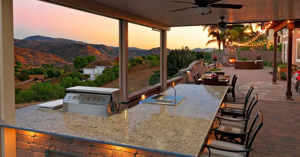 patio with outdoor kitchen and a view