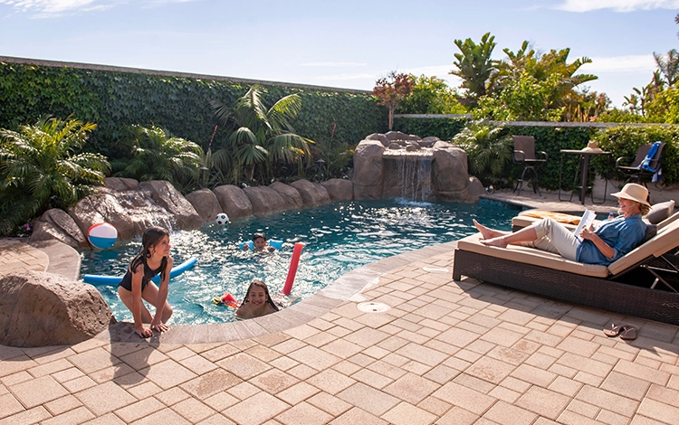 Pool deck in California being enjoyed by a family. 