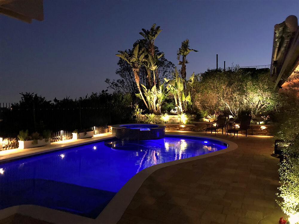 Southern California pool with paving stone deck and lighting