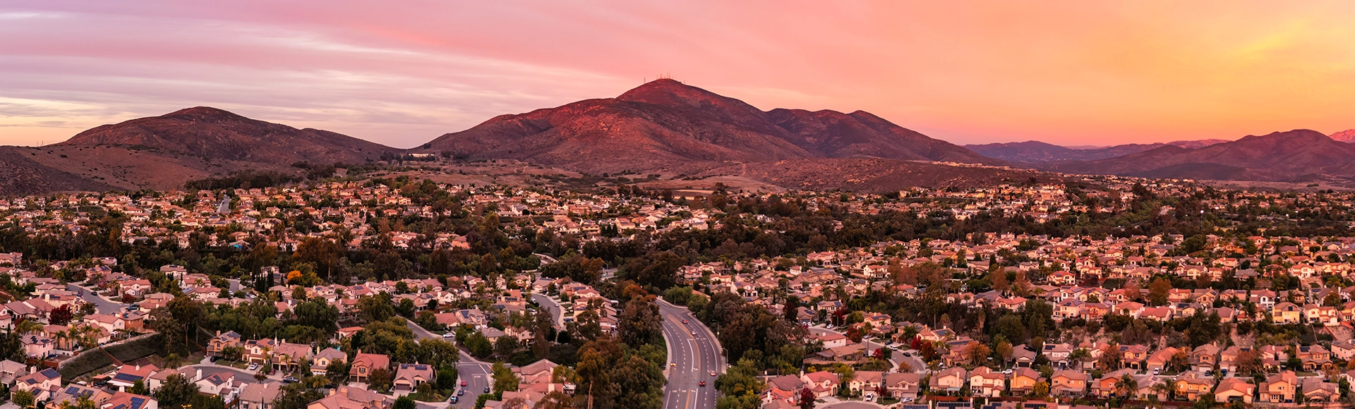 Landscape view of Chula Vista, California. City homes and mountains in the background at sunset. 