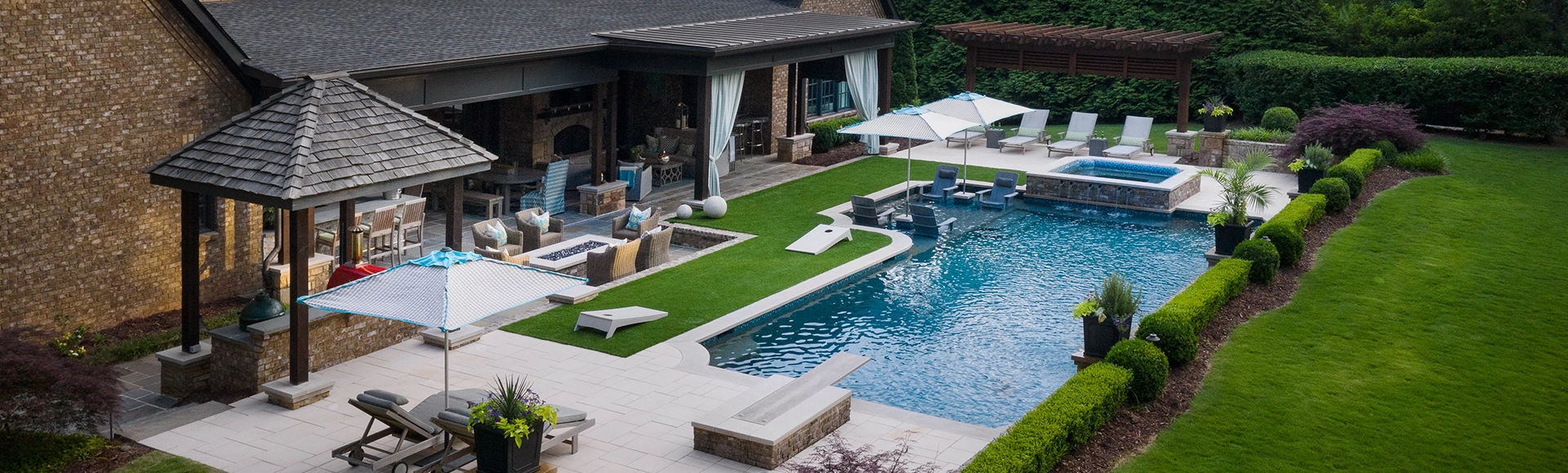 Large space with paving stone pool deck and turf lawn