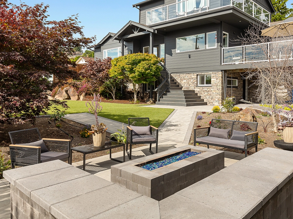 Paving stone fire pit and seating area in a backyard in Oregon.