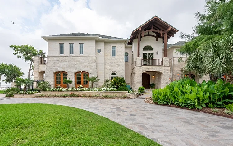 Long stone driveway with big house. 