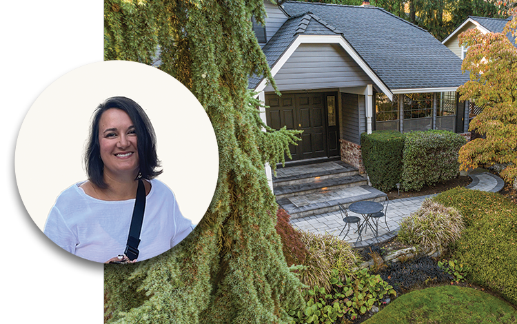 Picture of Eliza Webb in front of a Seattle home with a System Pavers patio out the front door. 