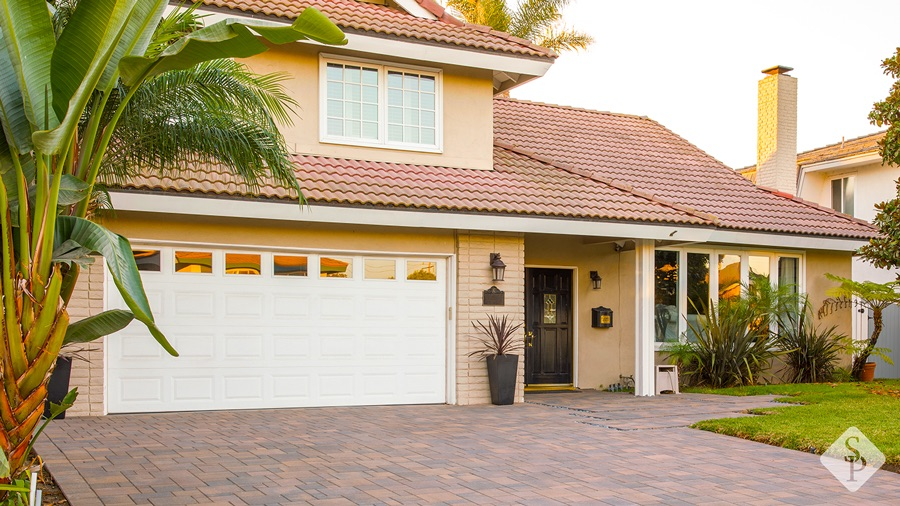 house with paver driveway